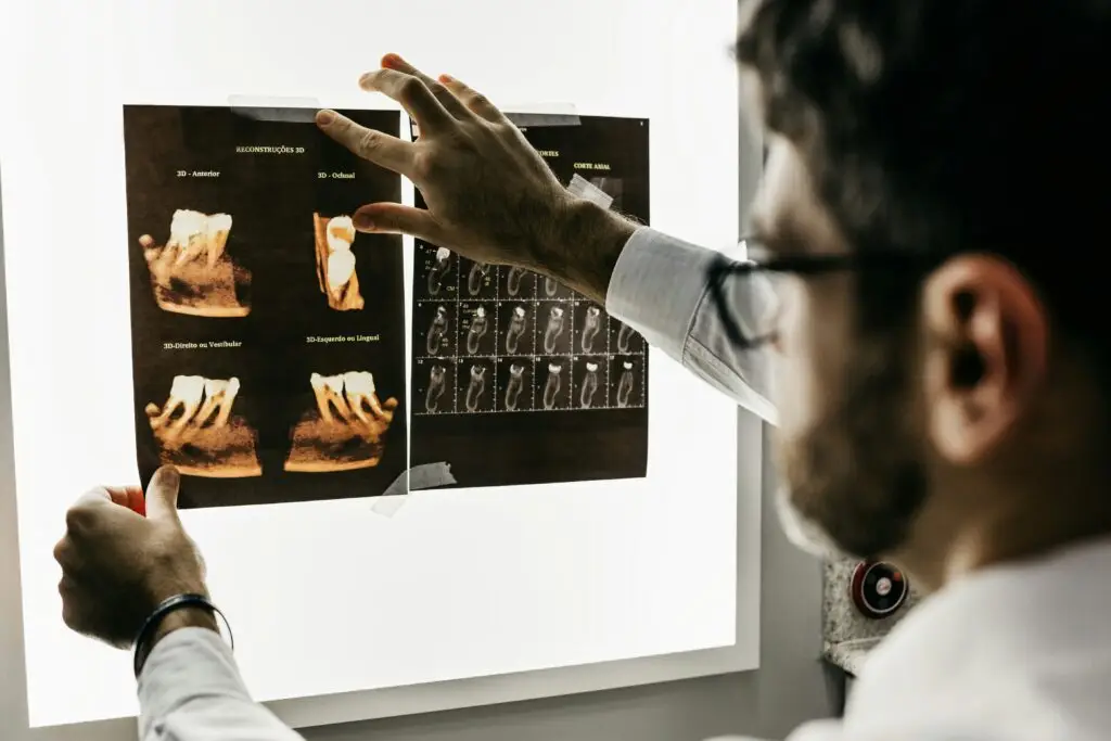 Dr. Charugundla Oral Surgeon examines a new patient x-ray in Portland.